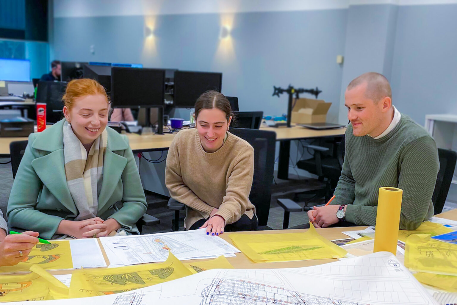 Landscape architecture and civil engineering consultants discuss site plans at Spiire Canberra.