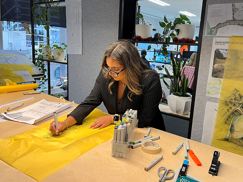 Spiire Melbourne Landscape Architecture Graduate Sarah Salerni working on drawings in the Melbourne office.