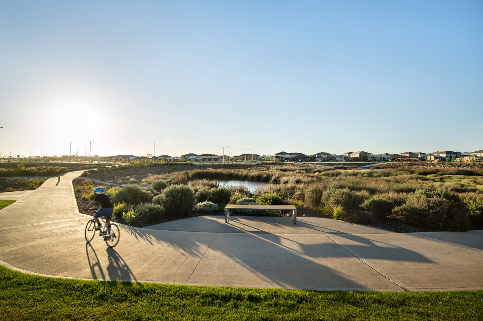 Cyclist using a pathway in the open space at Upper Point Cook estate.